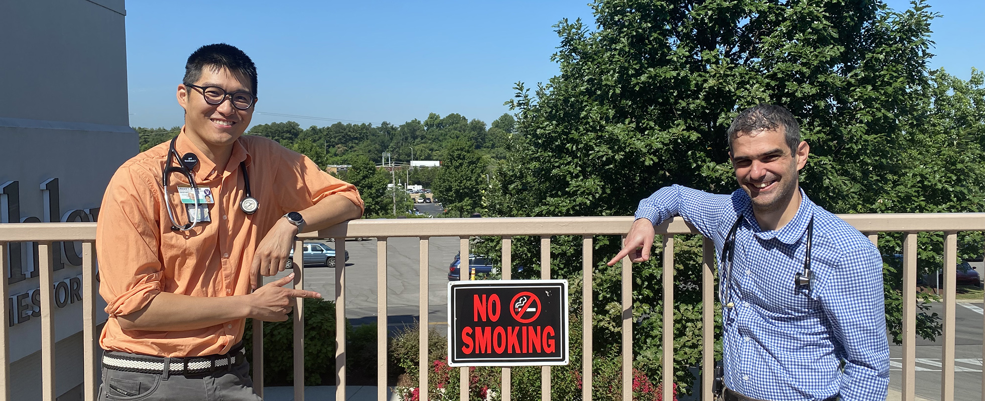 Fellows highlighting No Smoking sign