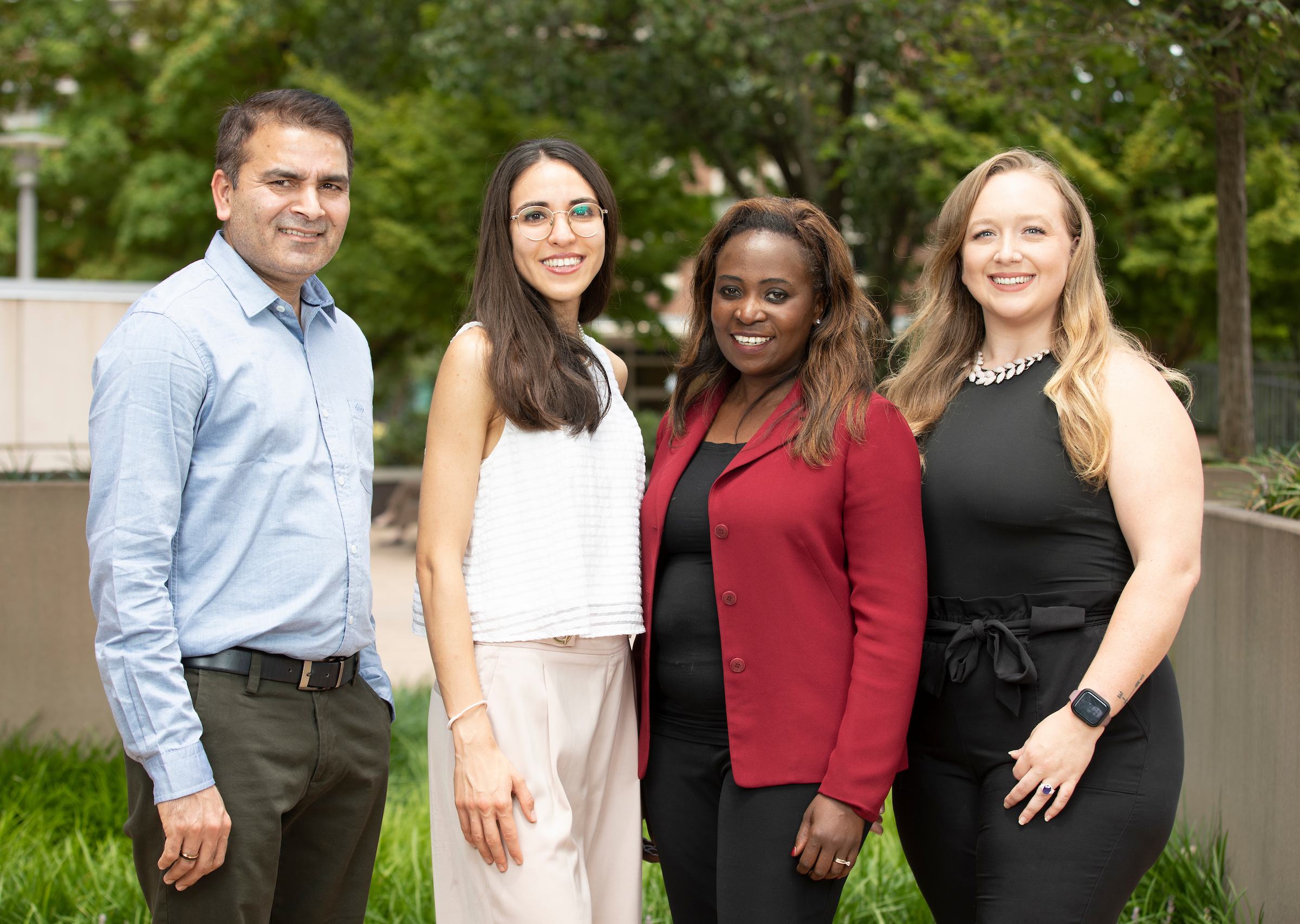 Dr. Annet Kirabo and 3 lab members pose outside on the VUMC campus.