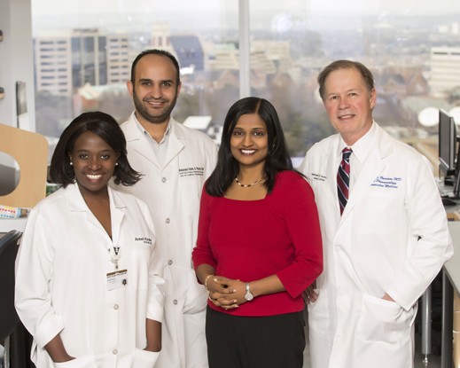 Dr. Annet Kirabo and 3 colleagues pose in their VUMC research lab.