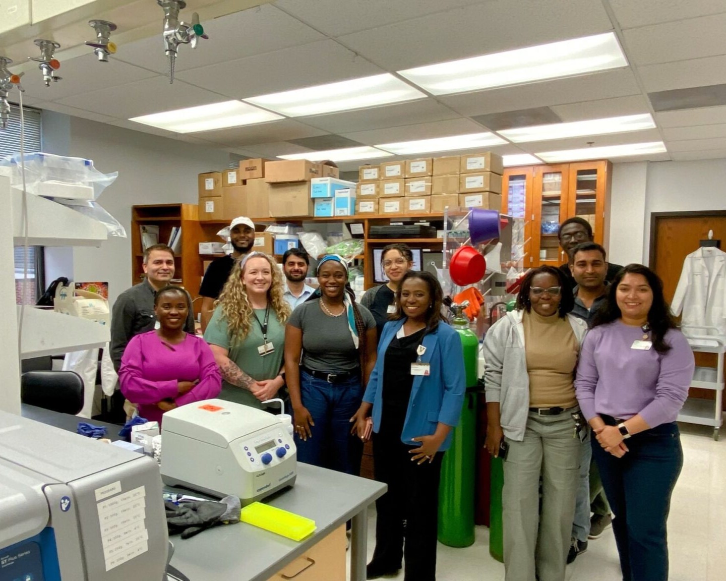 Dr. Annet Kirabo and her lab members pose in their scientific research lab at VUMC