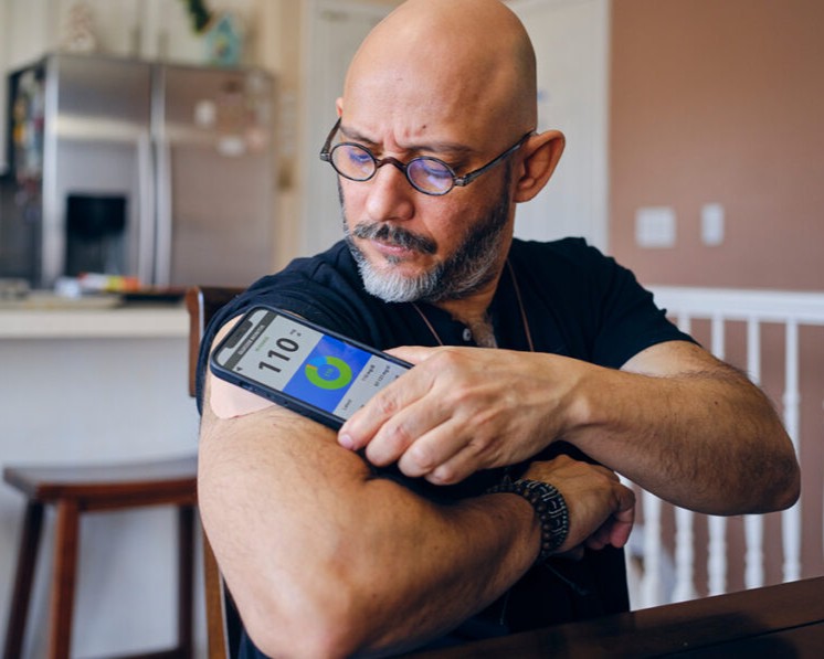 A man with diabetes checks his blood sugar level.