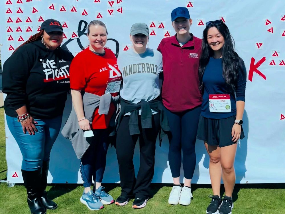 Five VDRC members in workout clothes pose after participating in the Step Out Walk.