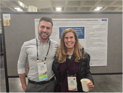 Dr. Felipe Ridolfi poses with a woman in front of a research poster.
